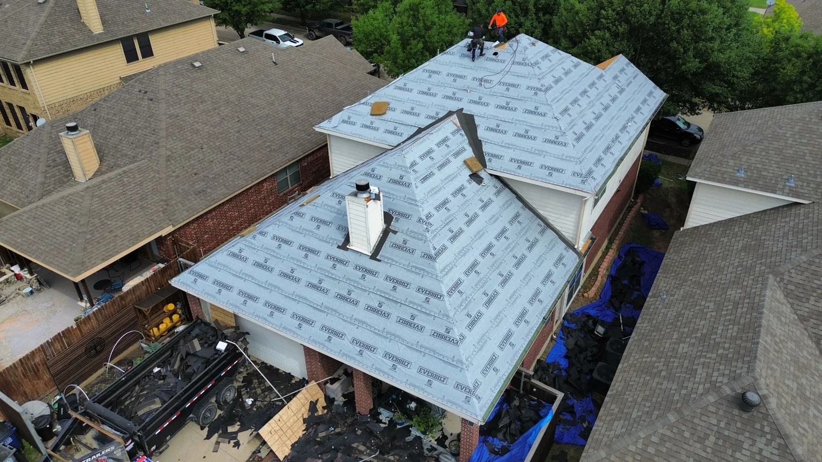 Crew installing underlayment on the same Red Oak roof